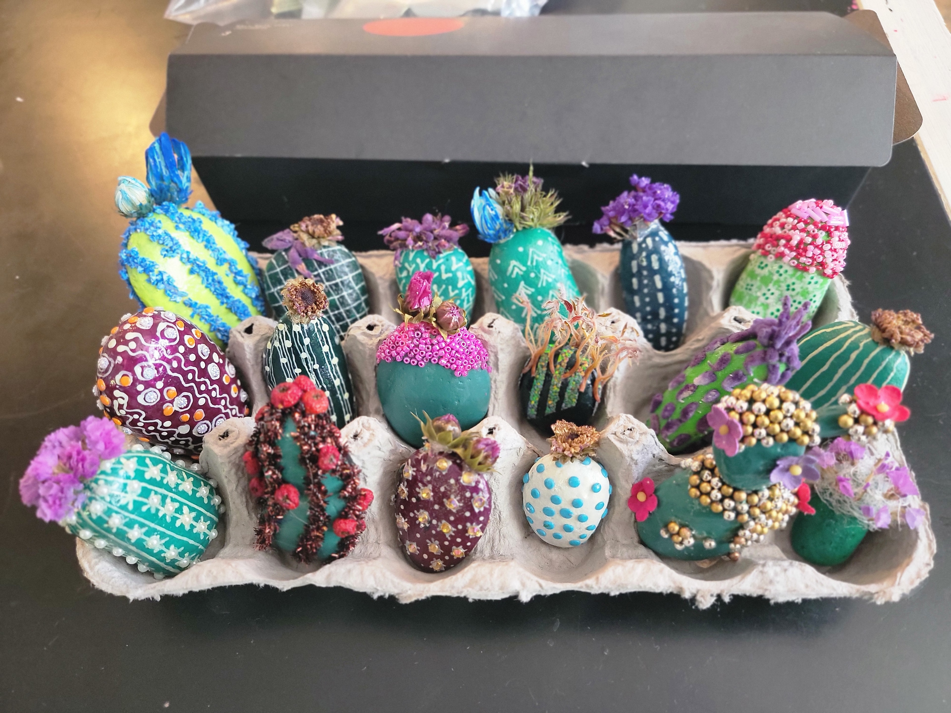 Colorful decorative cactus stones in a pot